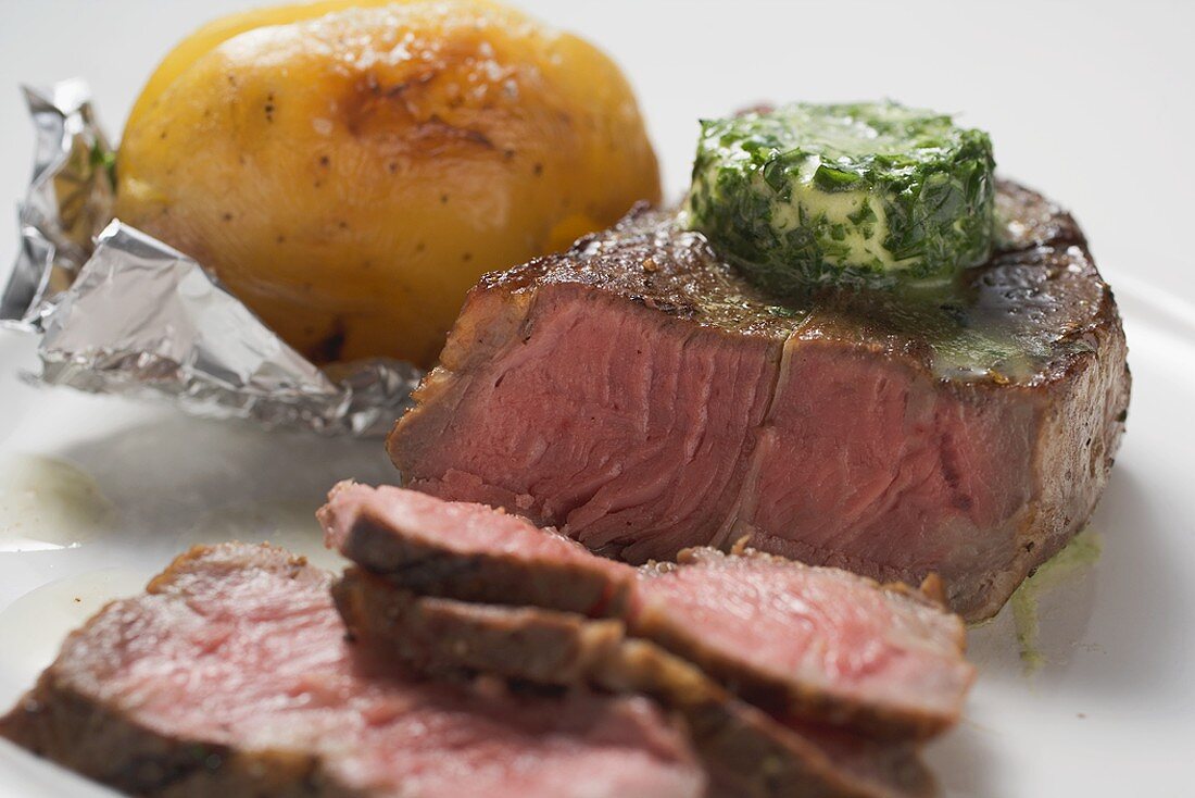 Beef steak with herb butter and baked potato