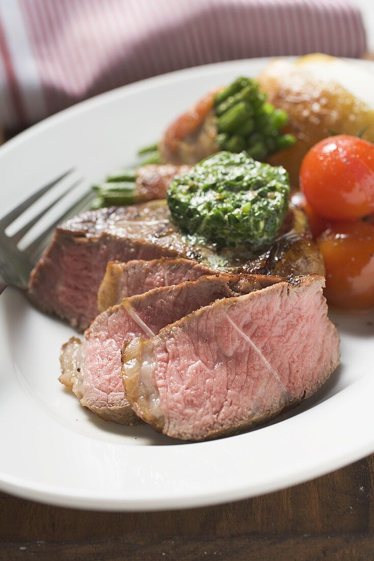 Beef steak with herb butter and accompaniments