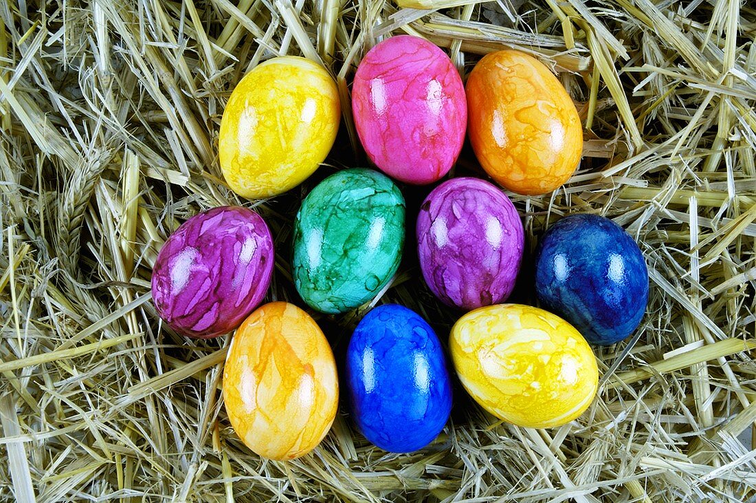 Coloured Easter eggs in straw