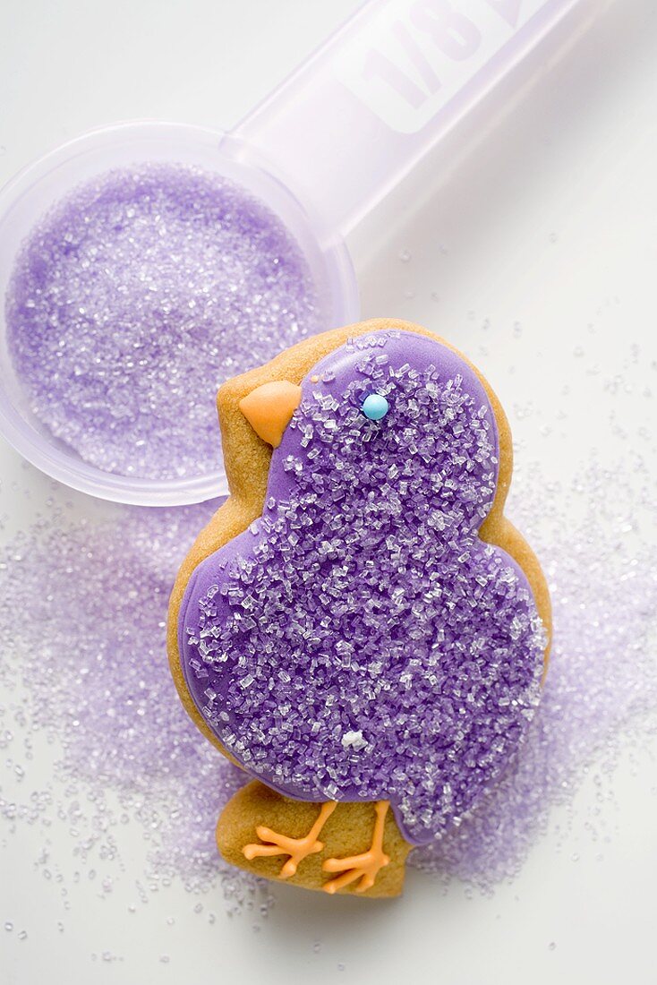 Easter biscuit (purple chick) and sugar for decorating