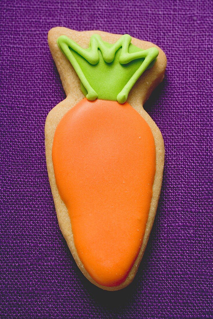 Easter biscuit (carrot) on purple linen