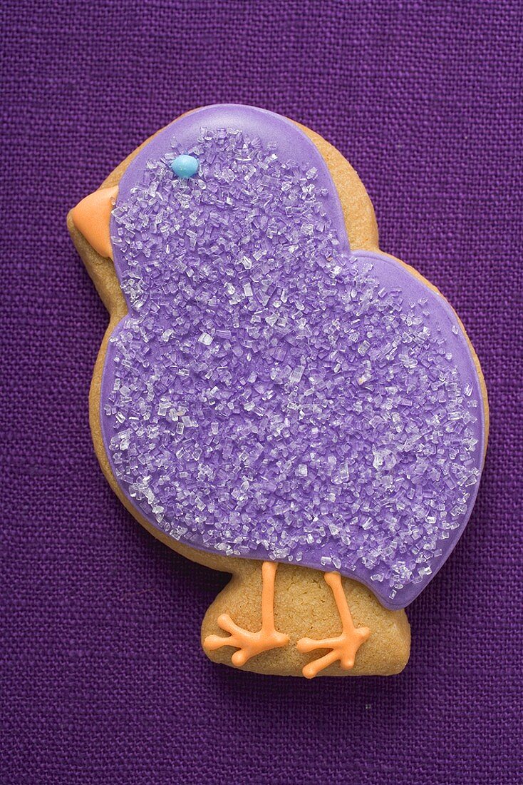 Easter biscuit (purple chick) on purple linen