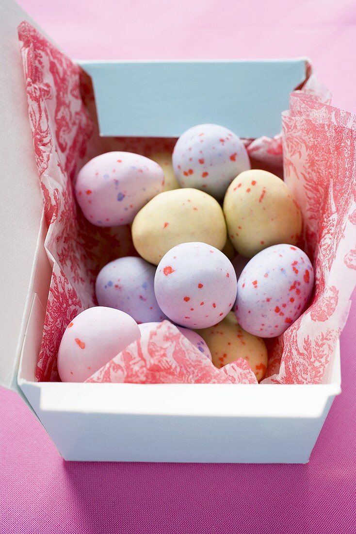 Pastel-coloured sugar eggs in box
