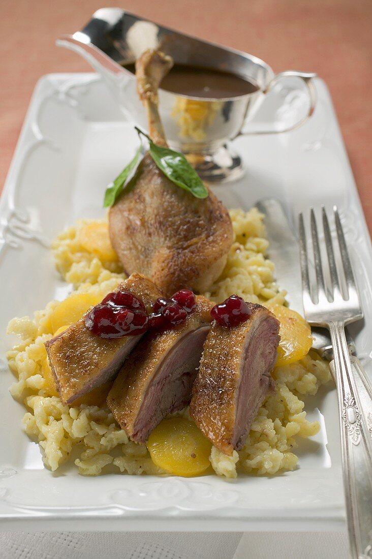 Pieces of roast goose on rice with carrots