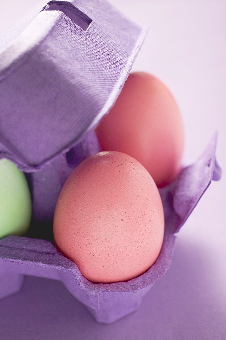 Coloured eggs in egg box