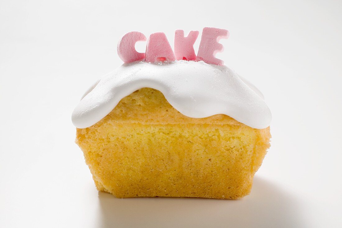 Iced loaf cake with the word 'Cake'