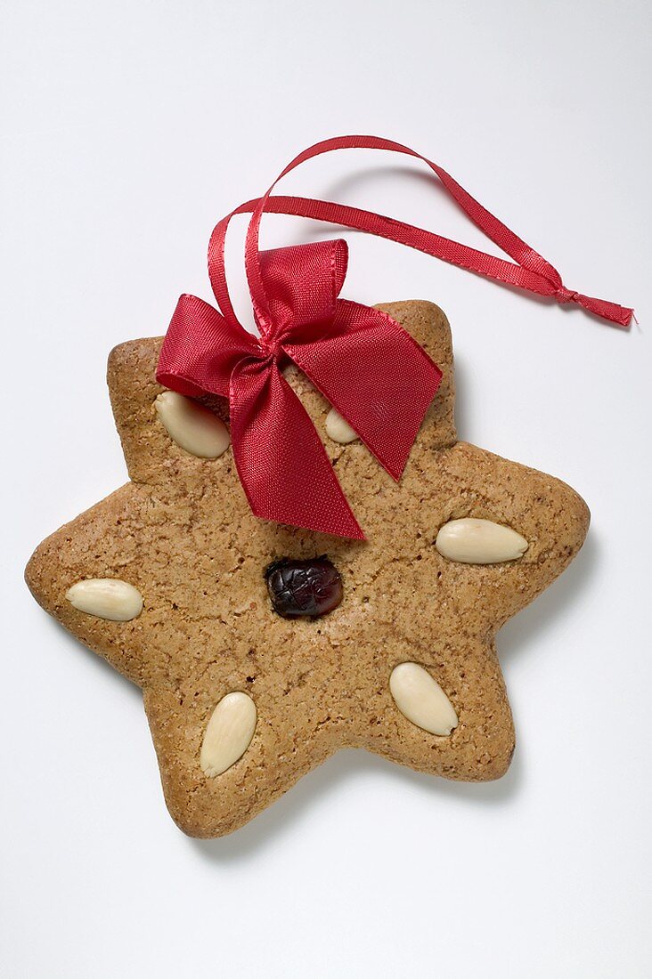 Gingerbread star with almonds and red bow