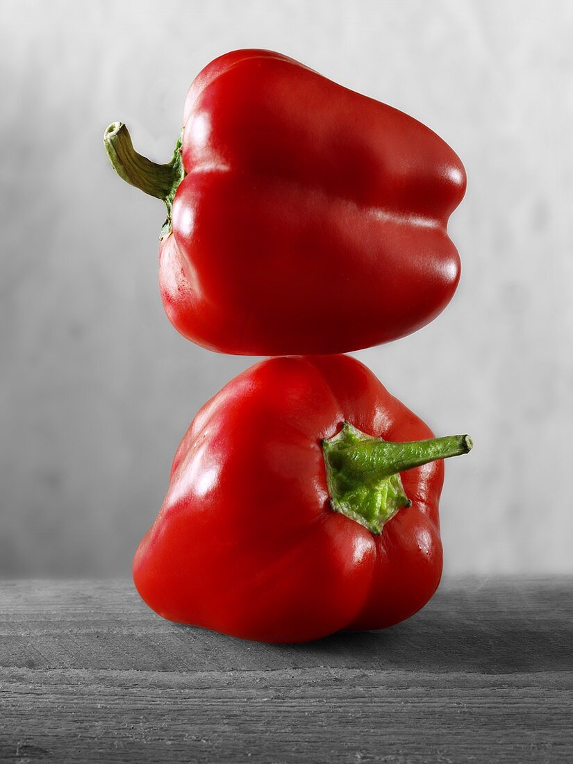 Two red peppers, one on top of the other