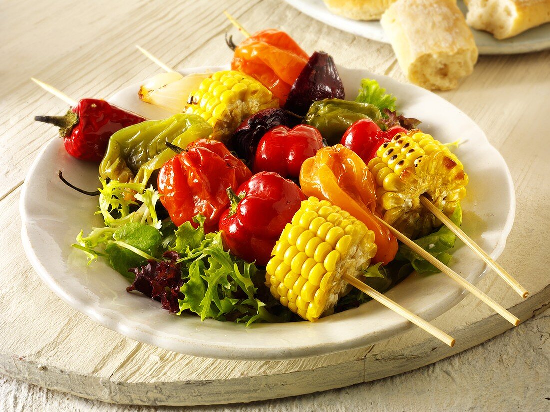 Colourful vegetable kebabs on salad leaves