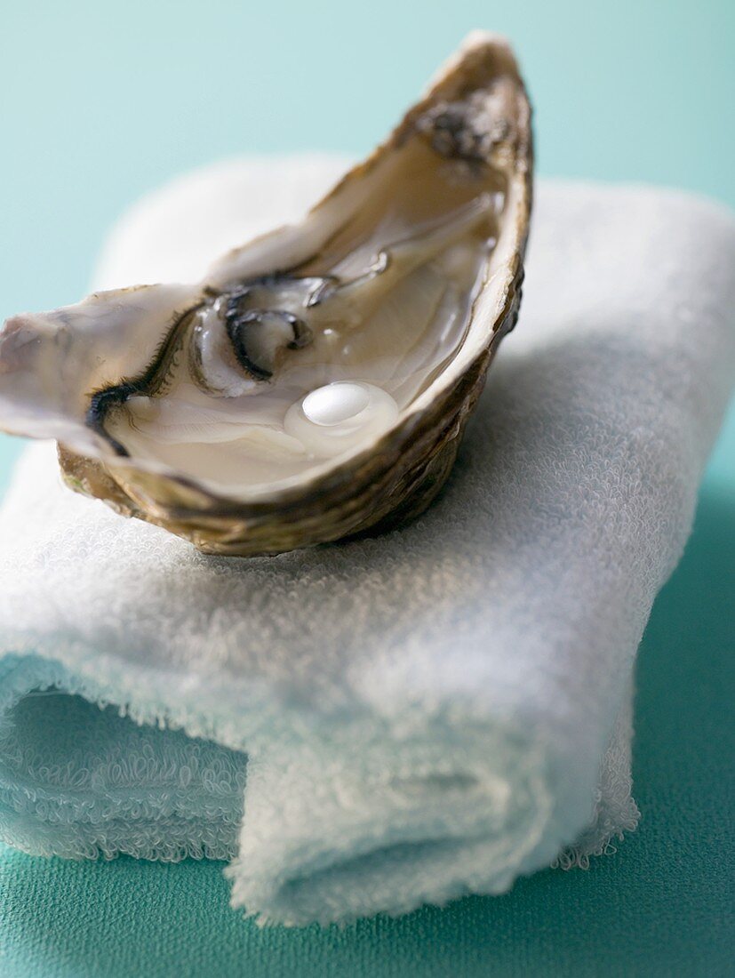 Fresh oyster with pearl on towels
