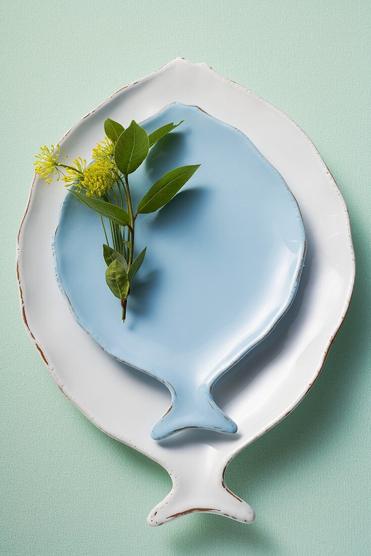 White and blue fish plates, decorated with herbs