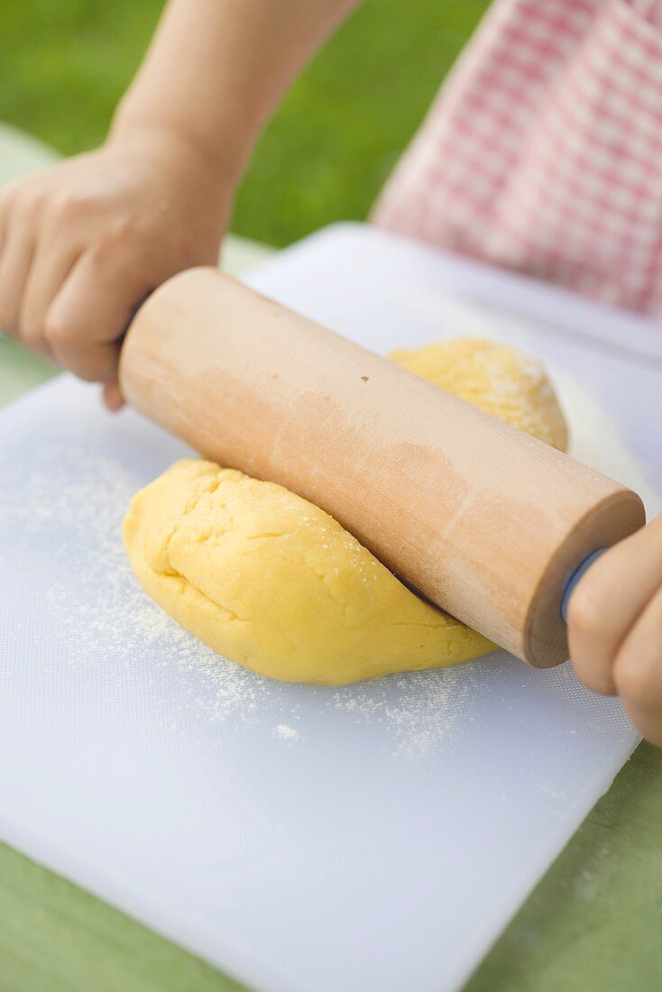 Child rolling out dough