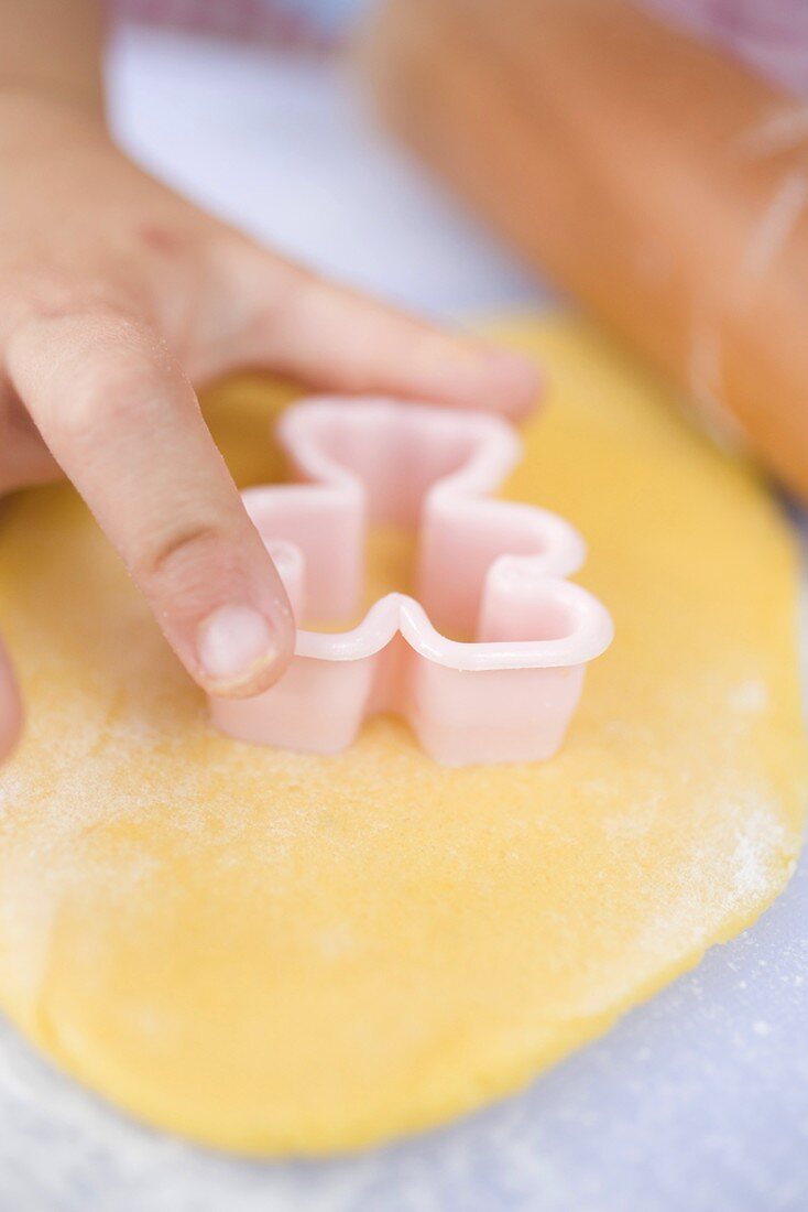 Child cutting out biscuits