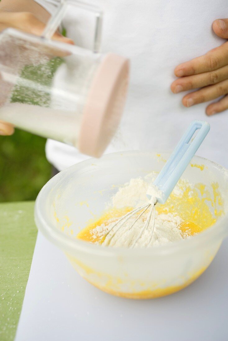 Adding flour to egg yolks