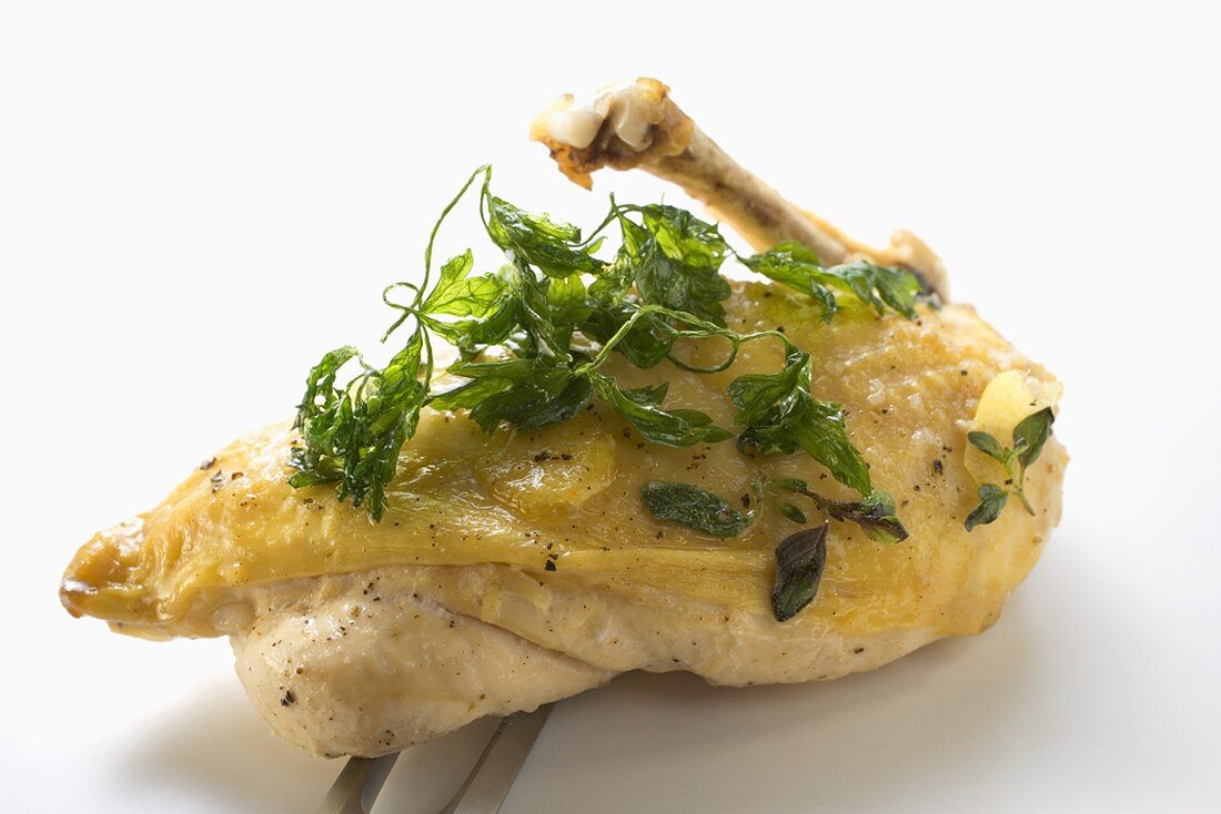 Chicken breast with deep-fried parsley on carving fork