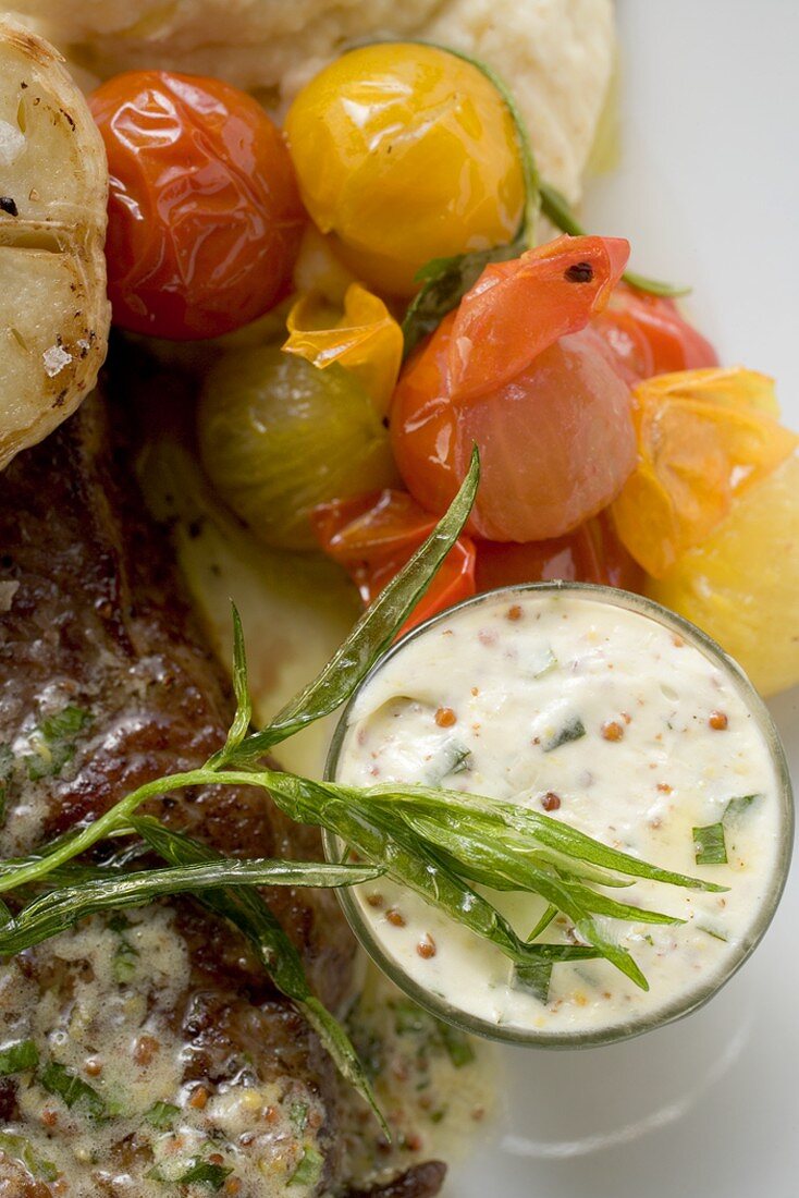 Beef steak with cherry tomatoes and mustard butter