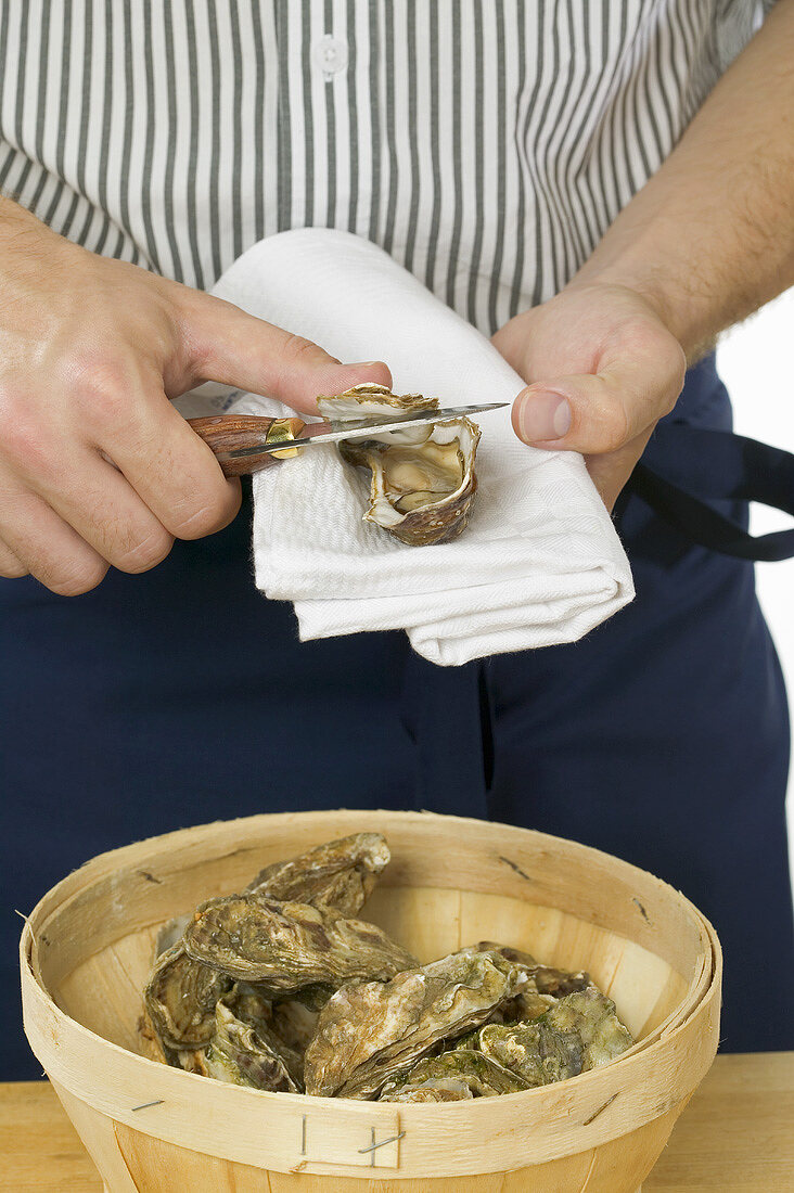 Man opening a fresh oyster
