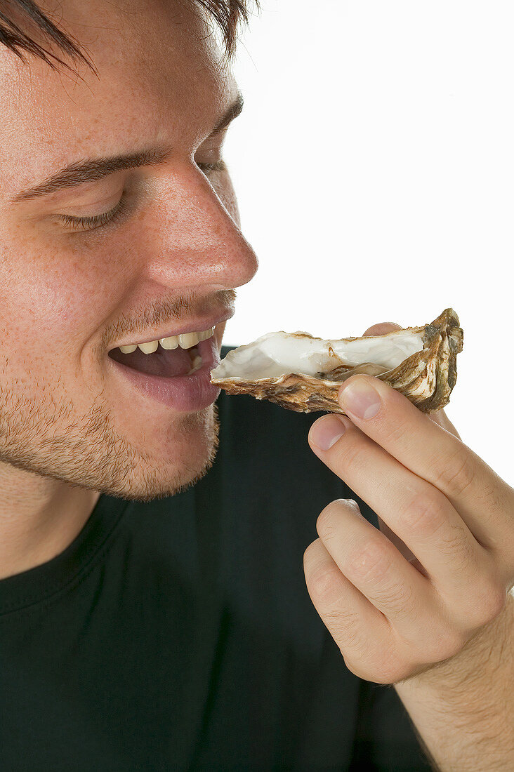 Man eating a fresh oyster