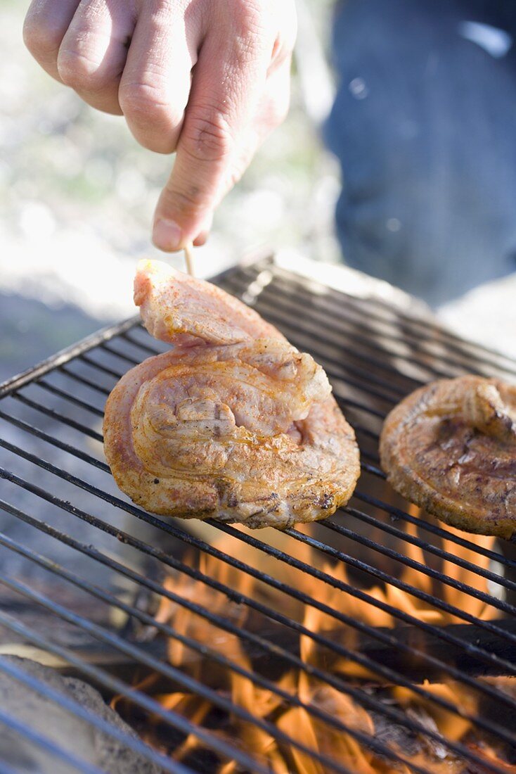 Pork on barbecue grill rack
