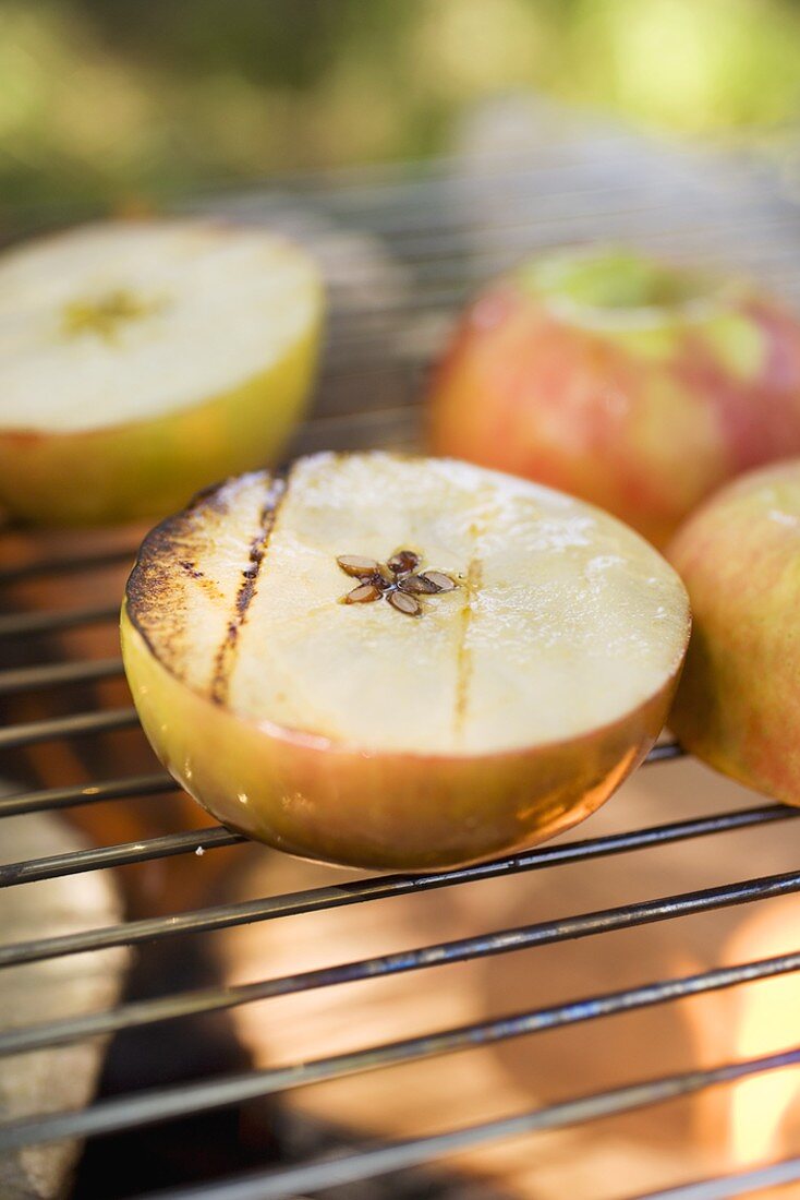 Grilled apples on barbecue grill rack
