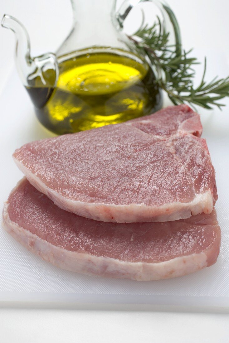 Two pork chops, olive oil, rosemary