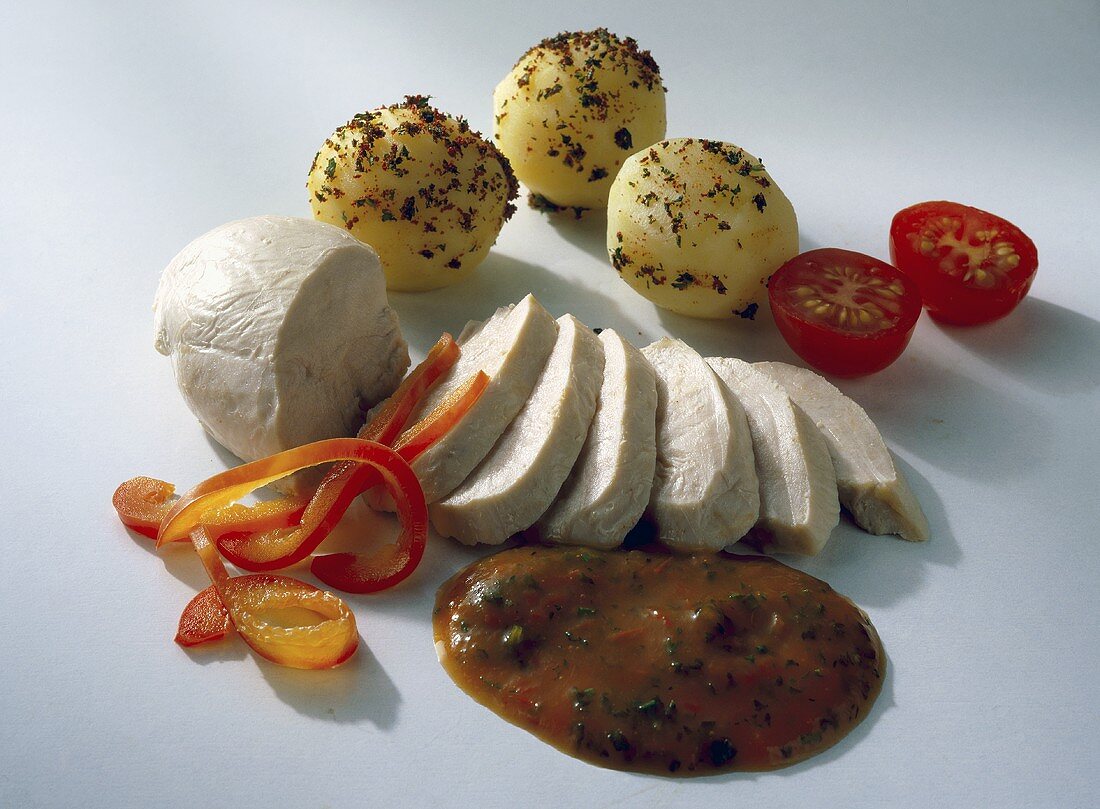 Steamed chicken breast, pepper sauce and seasoned potatoes