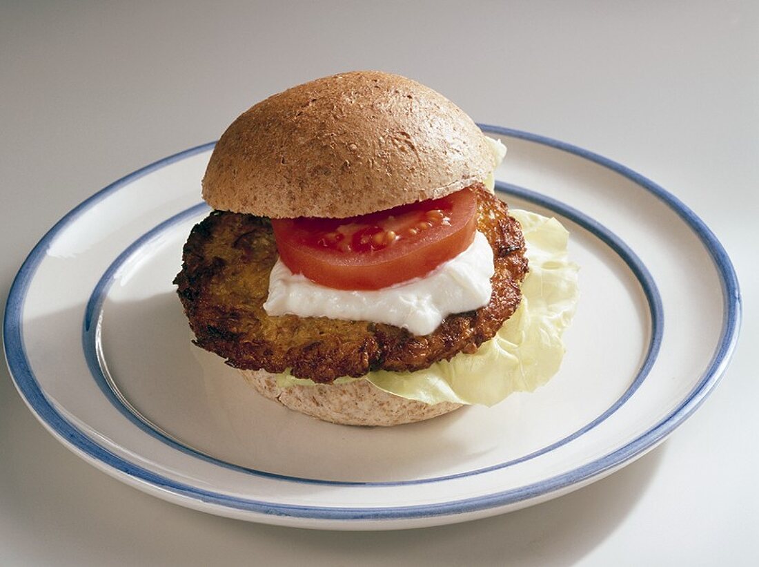 Fish burger with tomato and sour cream