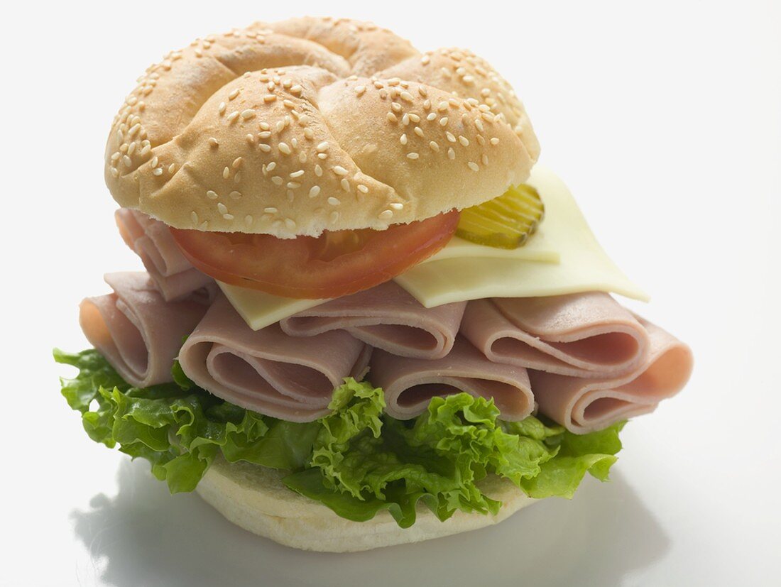 Sesame roll filled with ham, cheese, lettuce and tomato