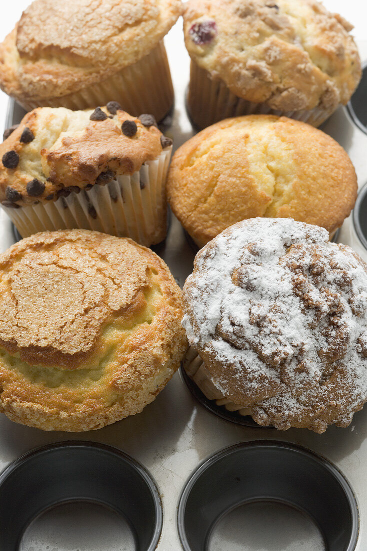 Assorted muffins in muffin tin (overhead view)