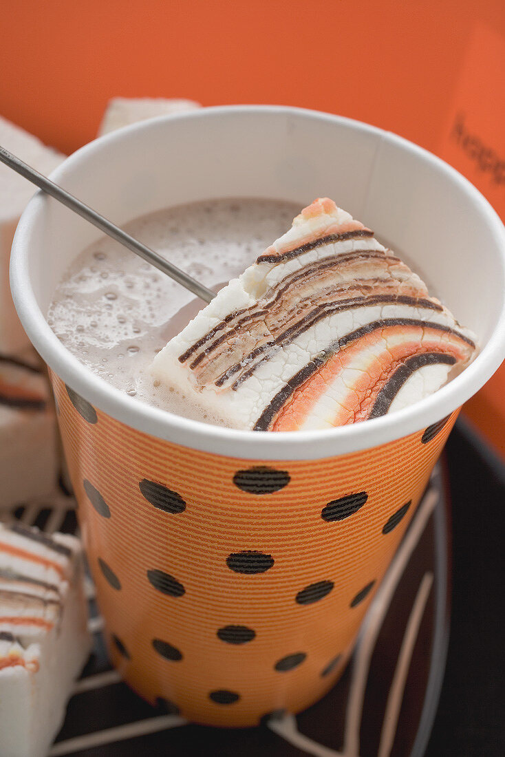 Cocoa with marshmallows in paper cup for Halloween