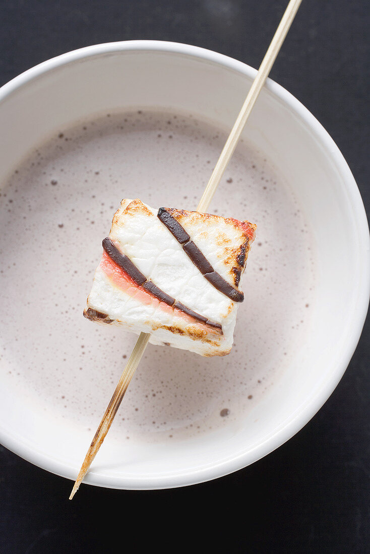 Cocoa with marshmallow on stick for Halloween