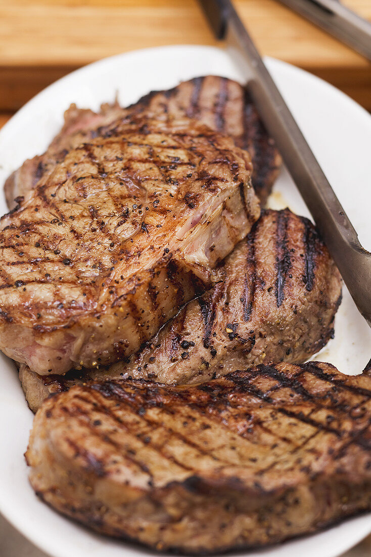 Grilled beef steaks on plate