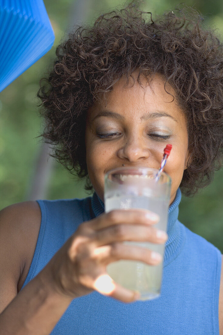 Woman drinking lemonade at a garden party