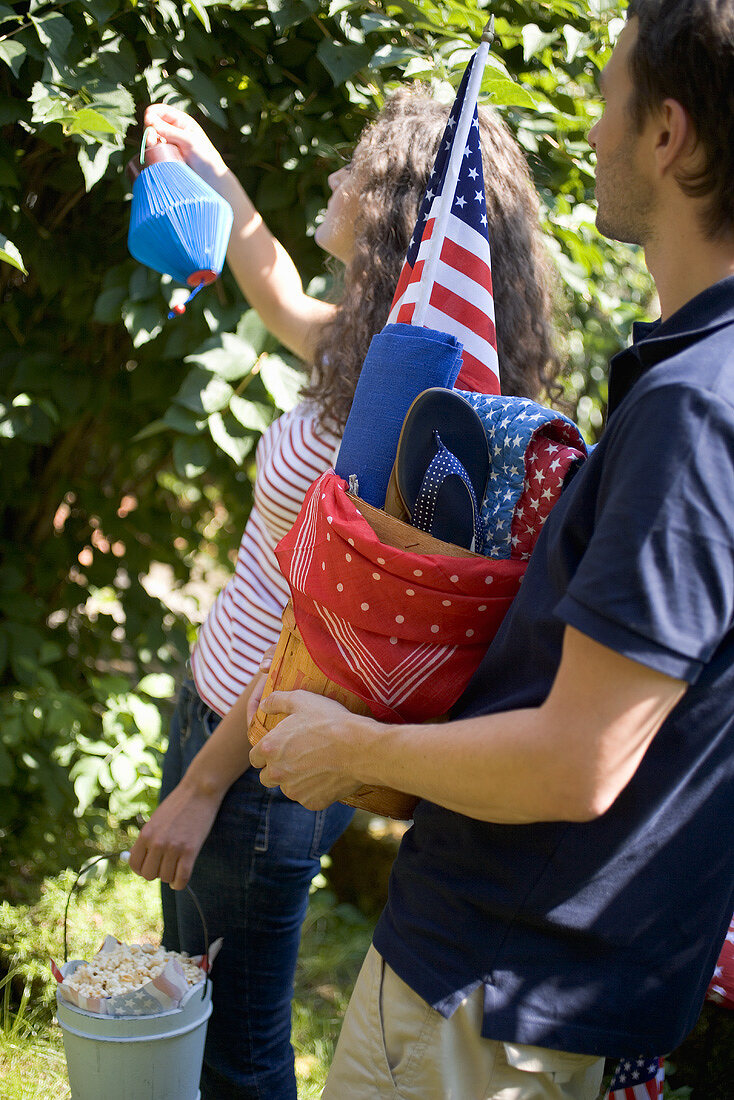 Couple with equipment for a 4th of July picnic (USA)