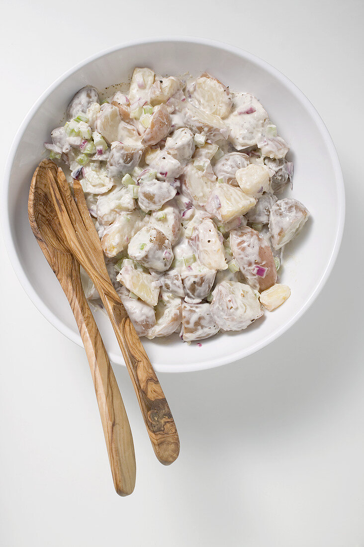 Potato salad in a bowl with salad servers