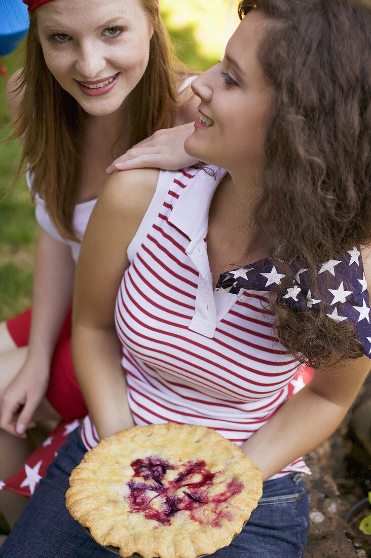 Women with blueberry pie at a 4th of July picnic (USA)