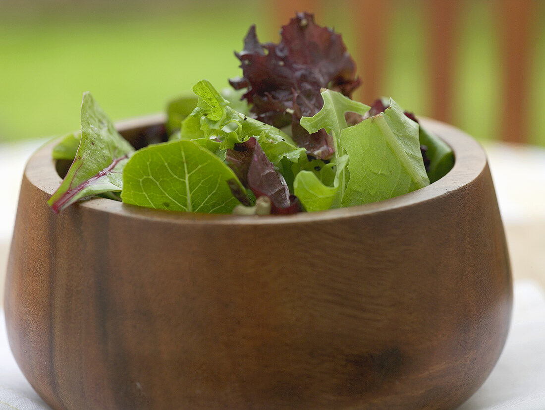 Mixed salad leaves in a wooden bowl
