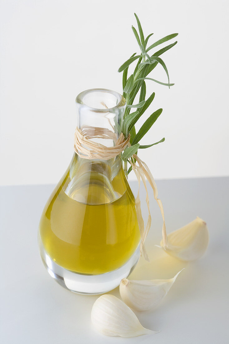 Olive oil in carafe, garlic and fresh rosemary