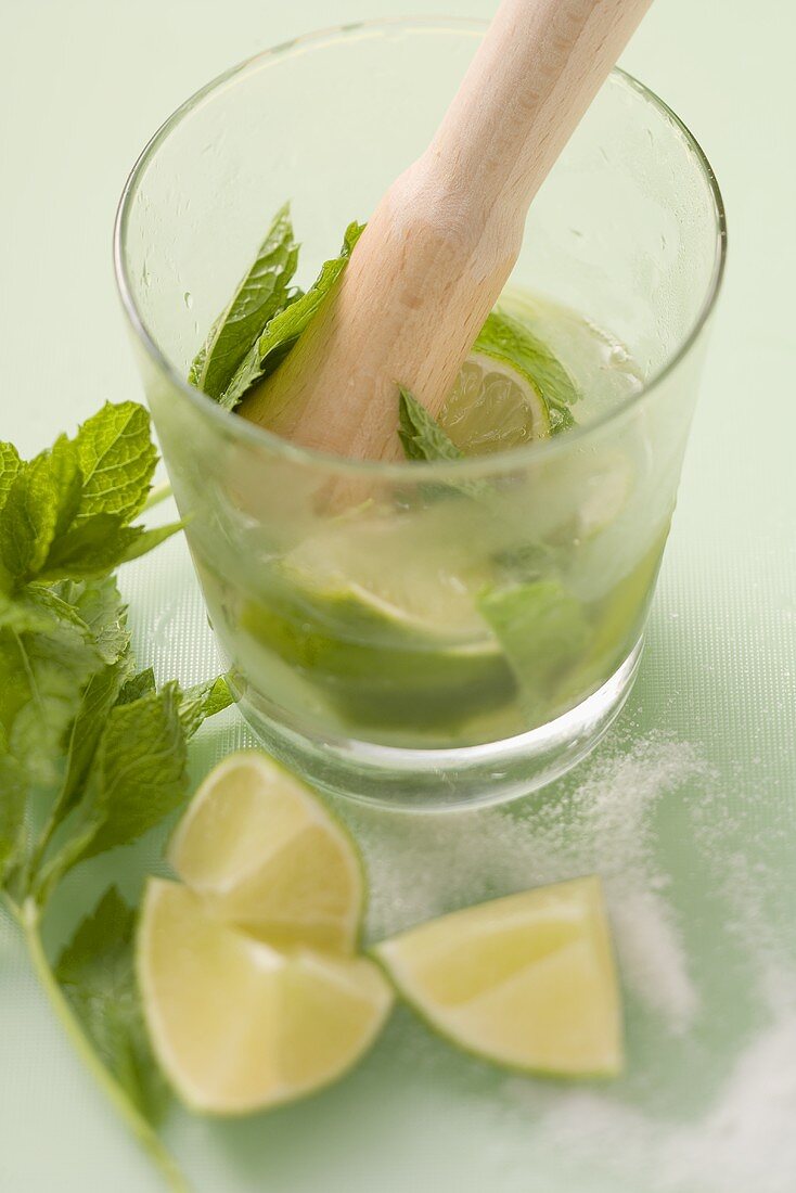 Making Mojito with lime and mint