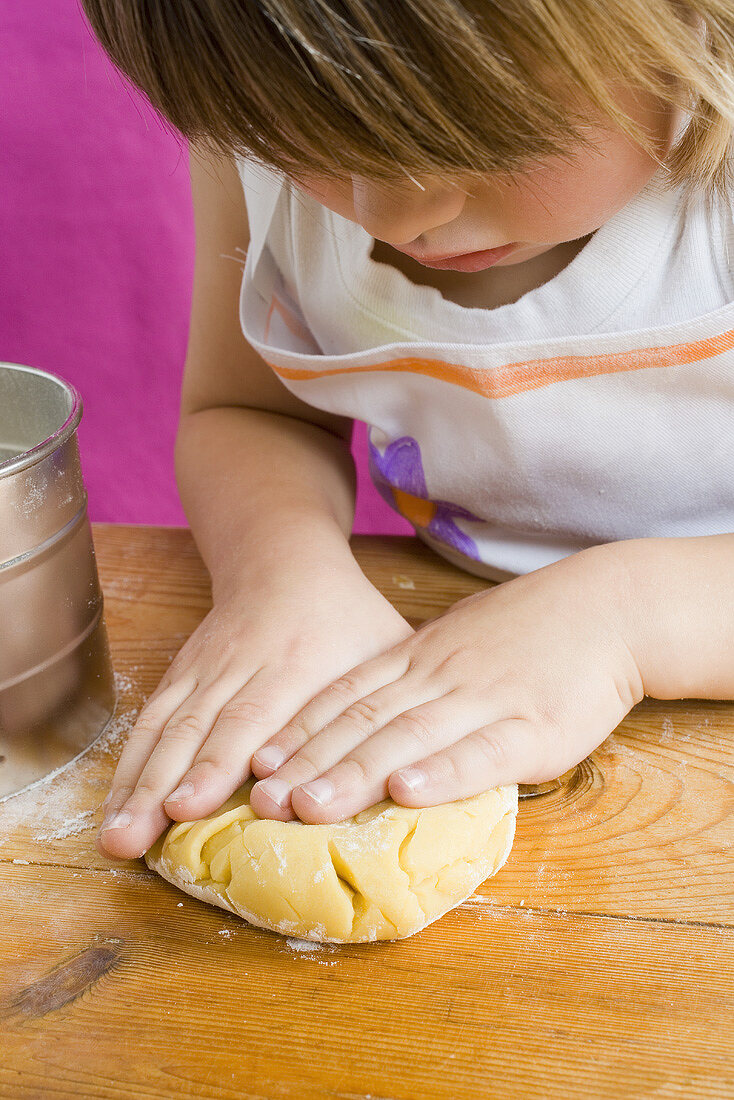 Child kneading dough
