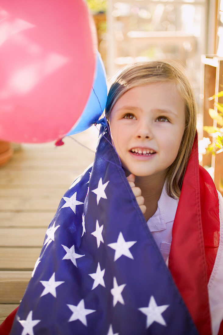 Small girl holding balloons (4th of July, USA)