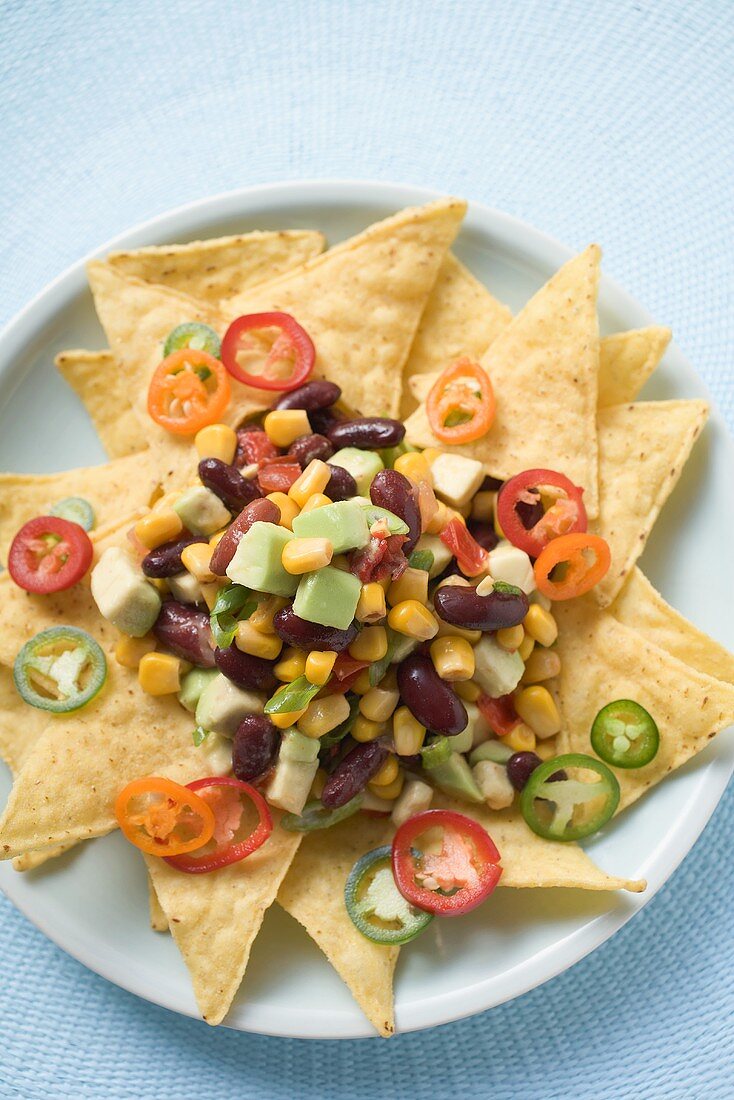 Nachos with beans, sweetcorn, avocado and chilli rings