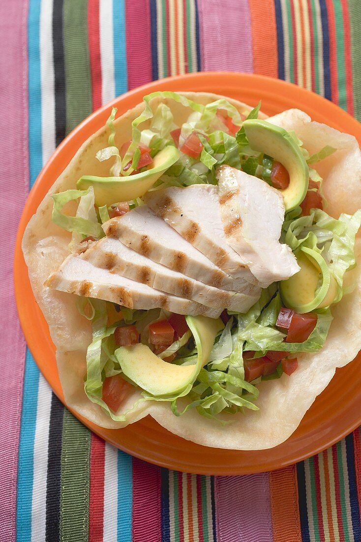 Chicken breast and avocado in tortilla shell