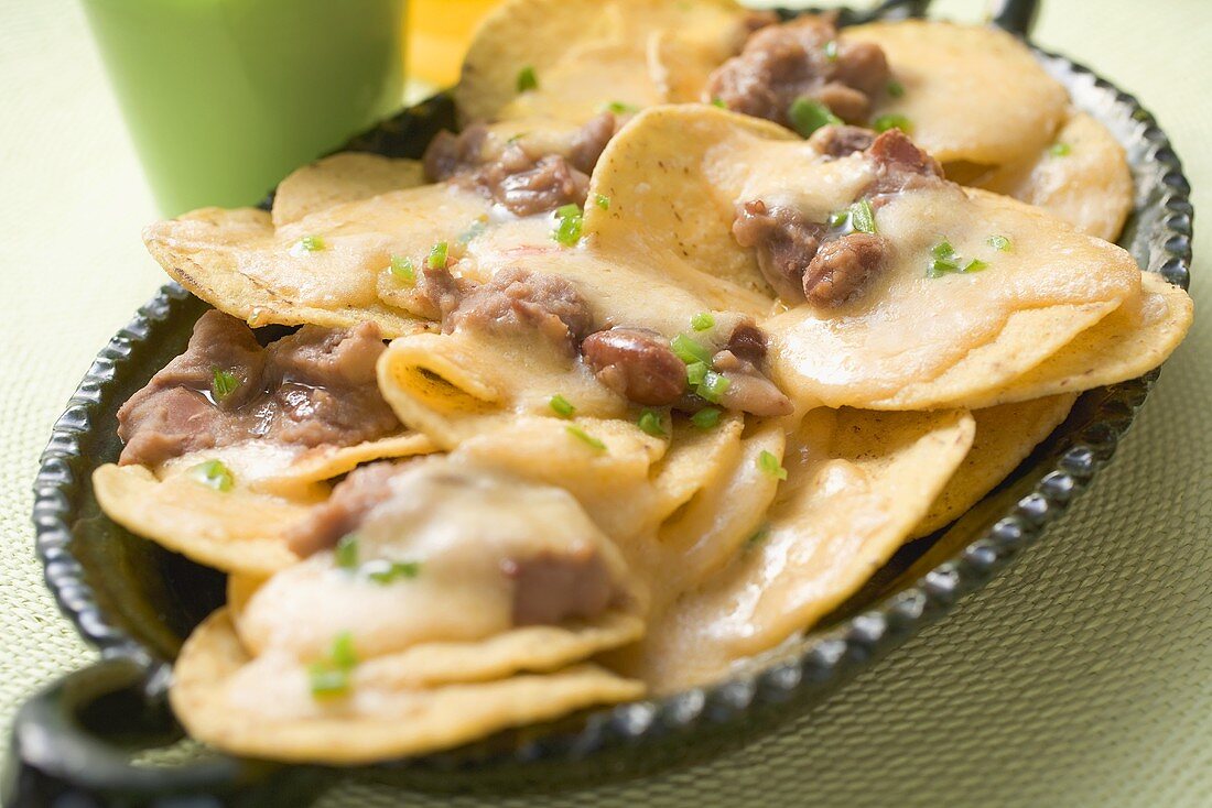 Tortilla chips with melted cheese and beans