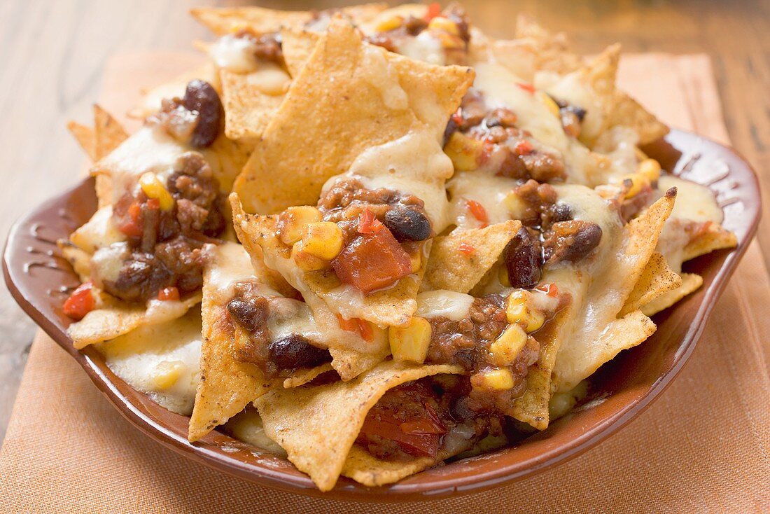 Tortilla chips with melted cheese, beans and mince