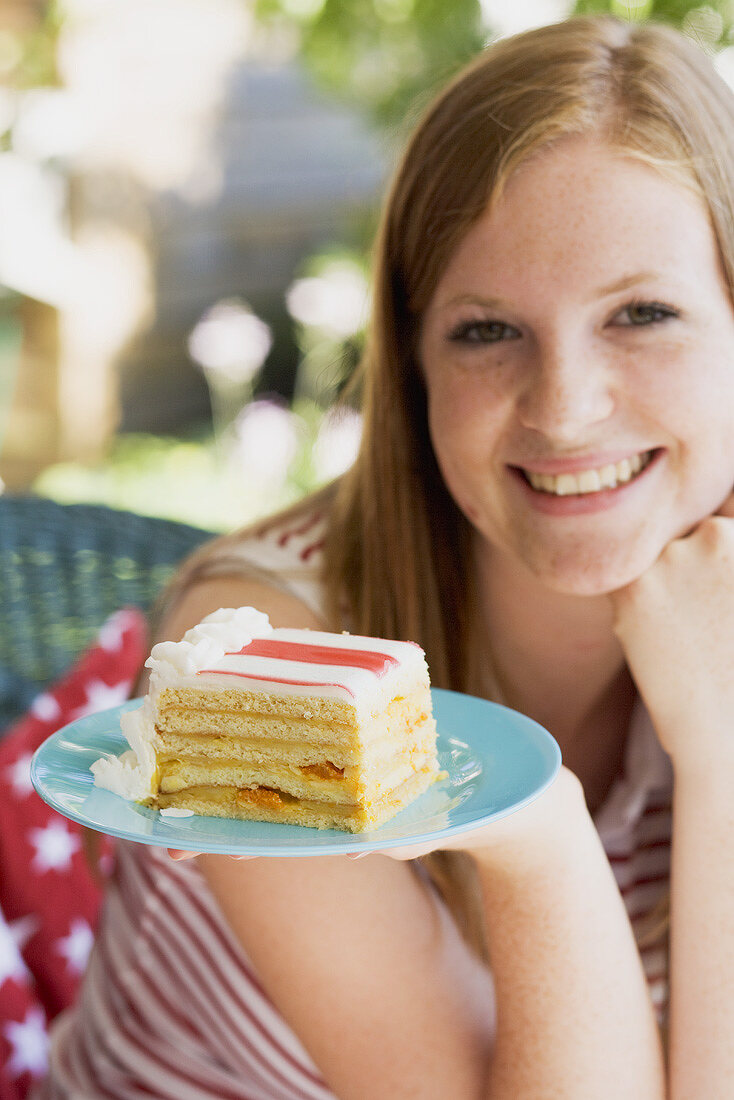 Woman holding a piece of cake on the 4th of July (USA)