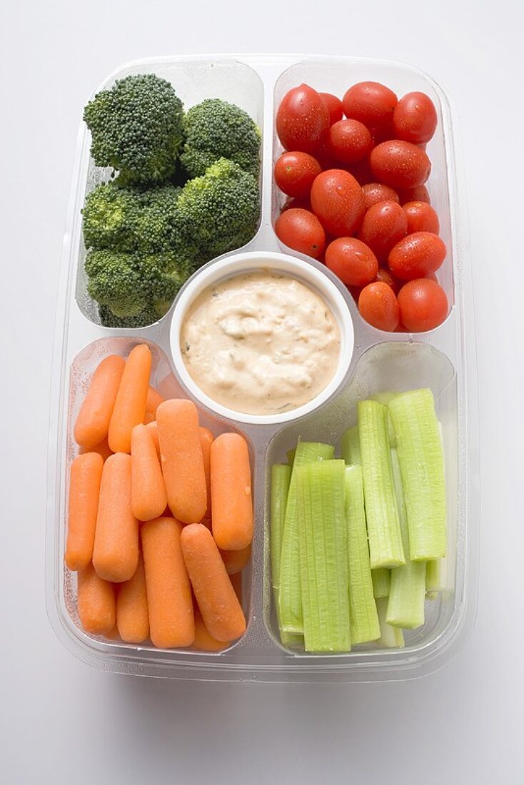 Assorted vegetables with dip in plastic tray