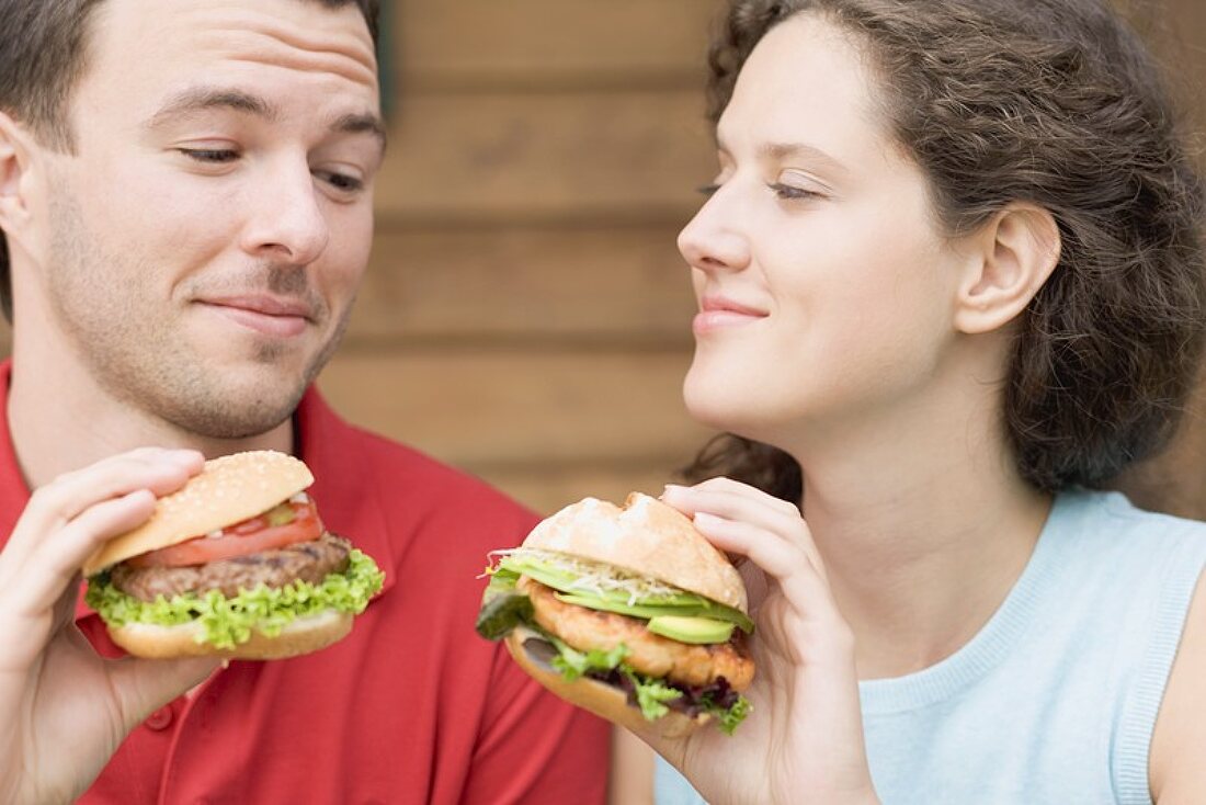 Couple with two different burgers