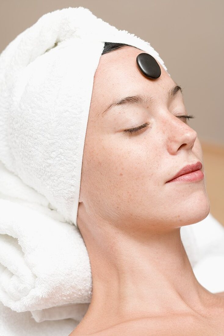 Woman having LaStone Therapy (healing therapy using stones)