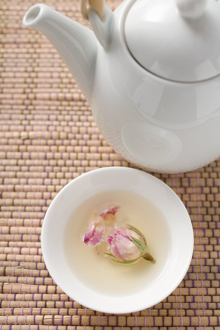 Teapot and bowl of rose tea